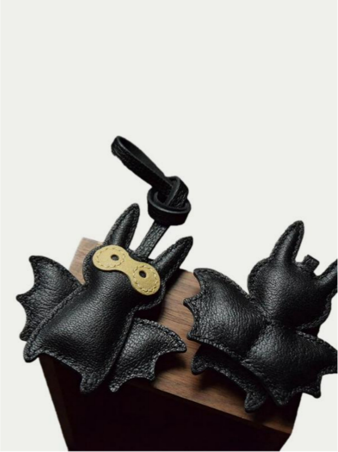 Close-up detail of the handmade bat charm showing the fine craftsmanship