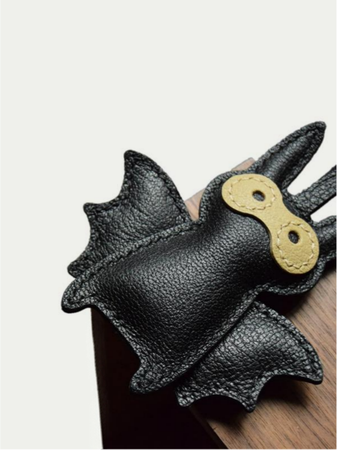 Close-up detail of the handmade bat charm showing the fine craftsmanship