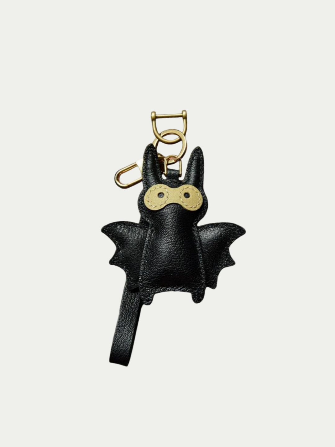 Close-up detail of the handmade bat charm showing the fine craftsmanship