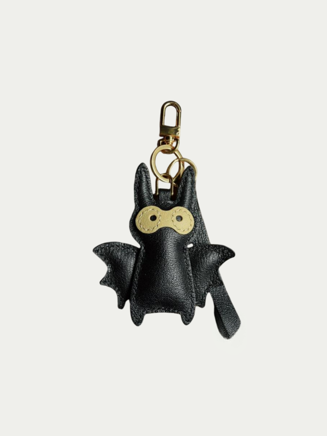 Close-up detail of the handmade bat charm showing the fine craftsmanship