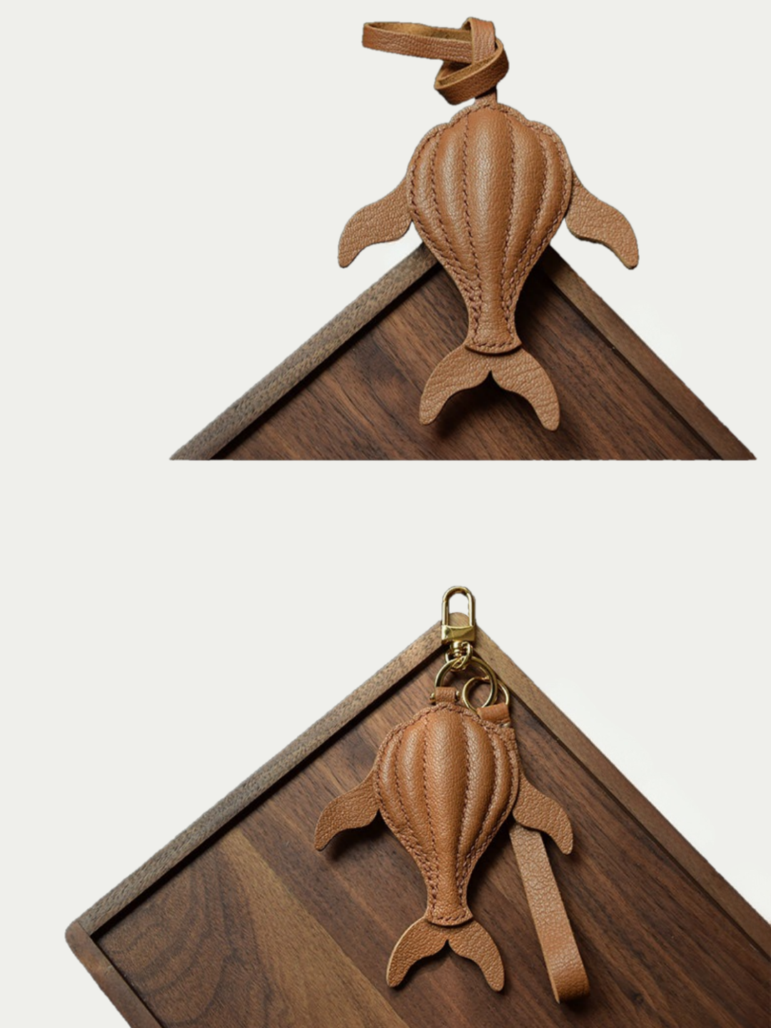 Ocean brown whale leather charm hanging from a cream handbag
