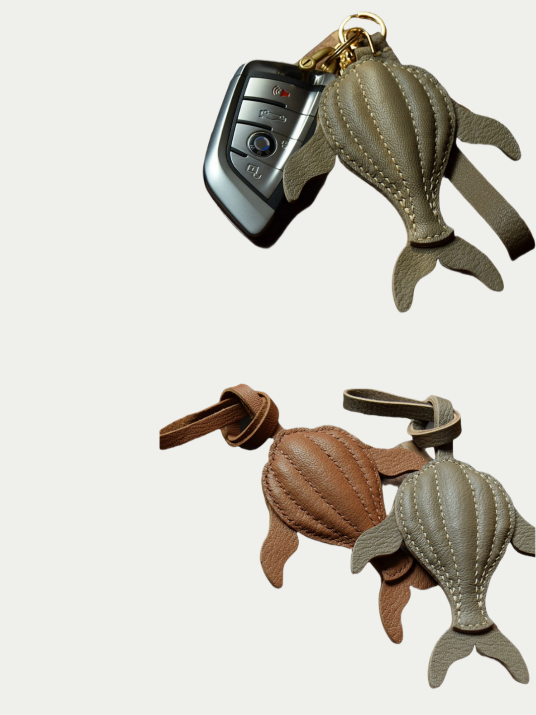 Ocean green whale leather charm hanging from a cream handbag

