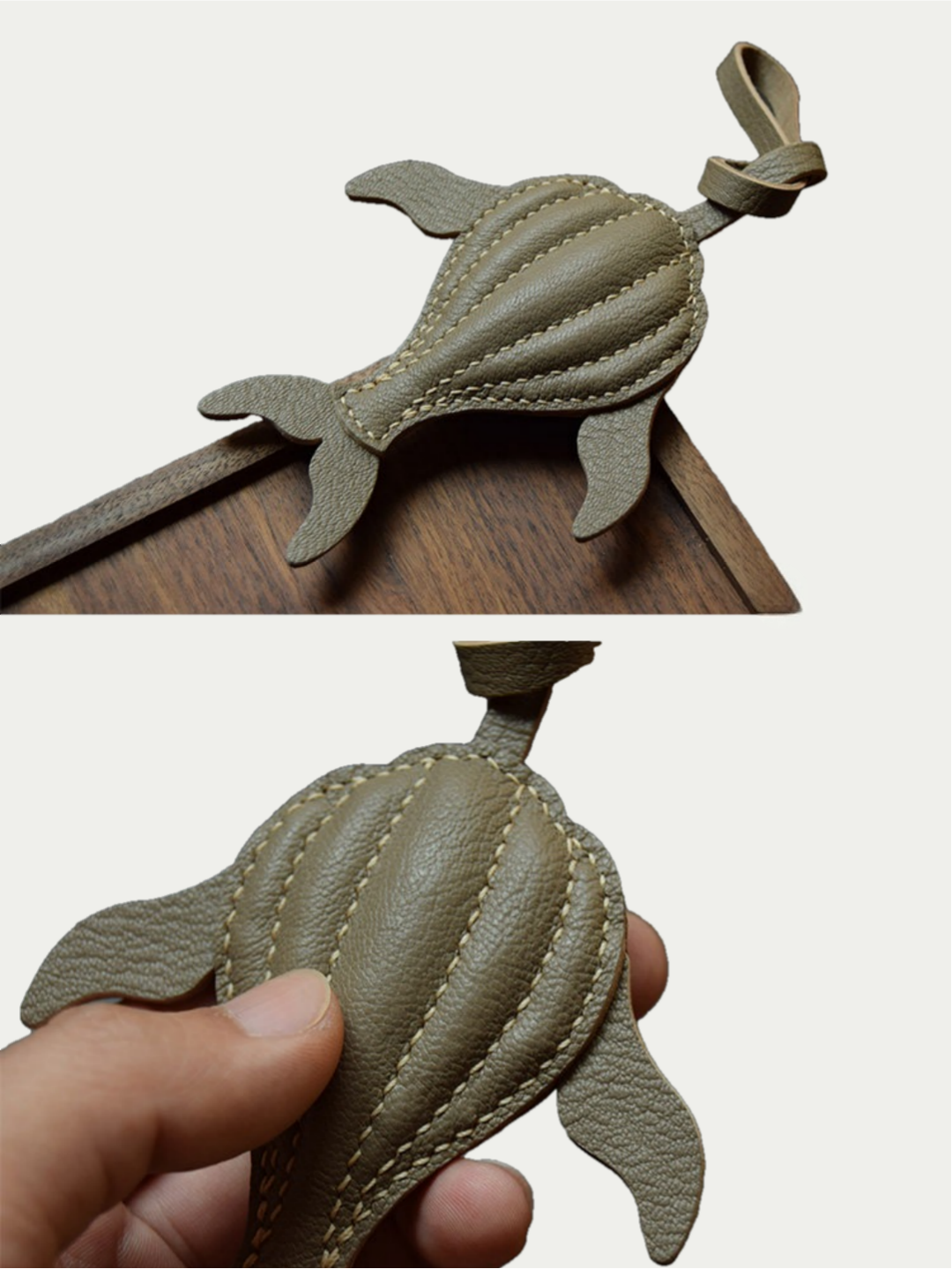Ocean green whale leather charm hanging from a cream handbag
