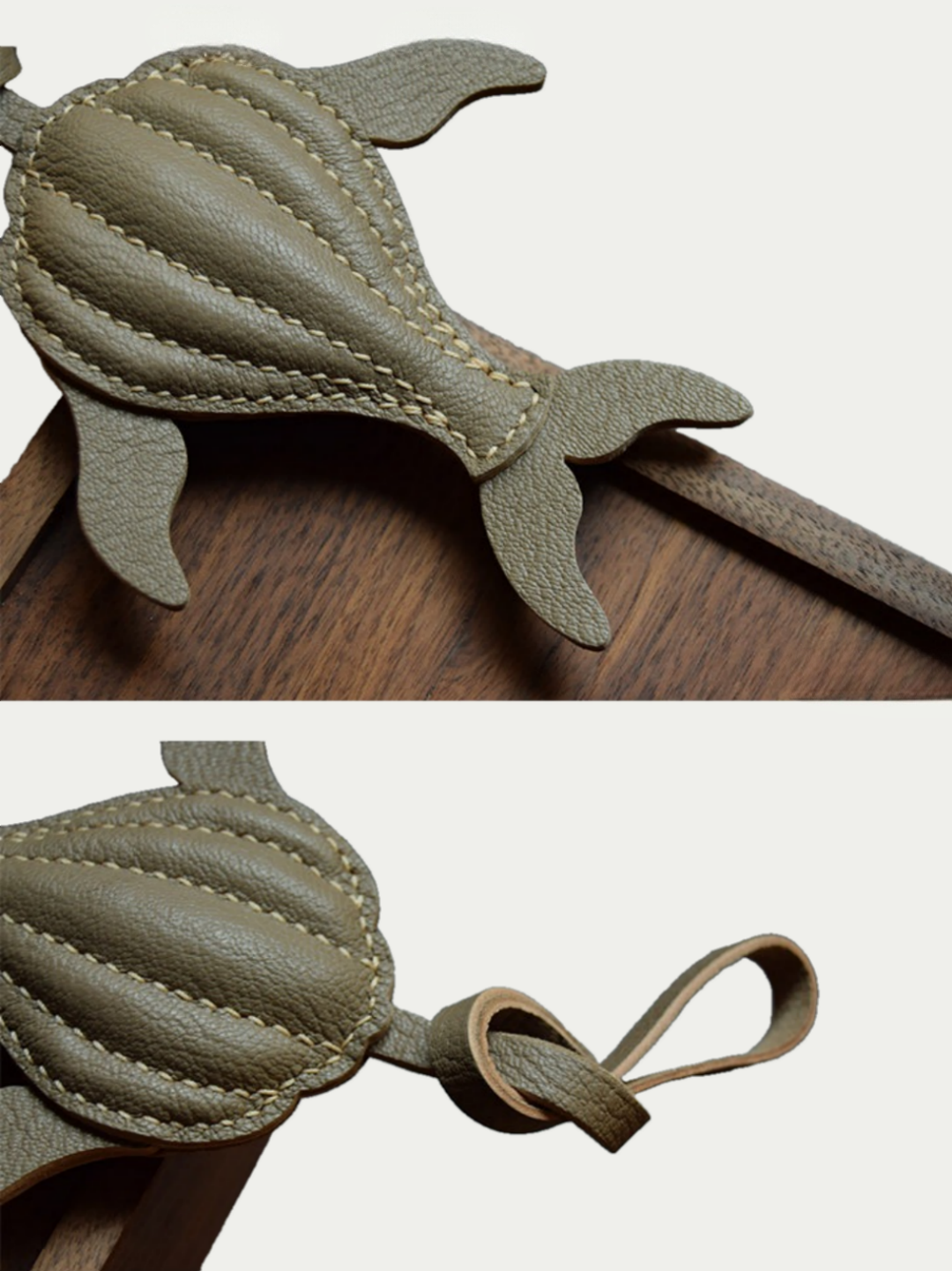 Ocean brown whale leather charm hanging from a cream handbag
